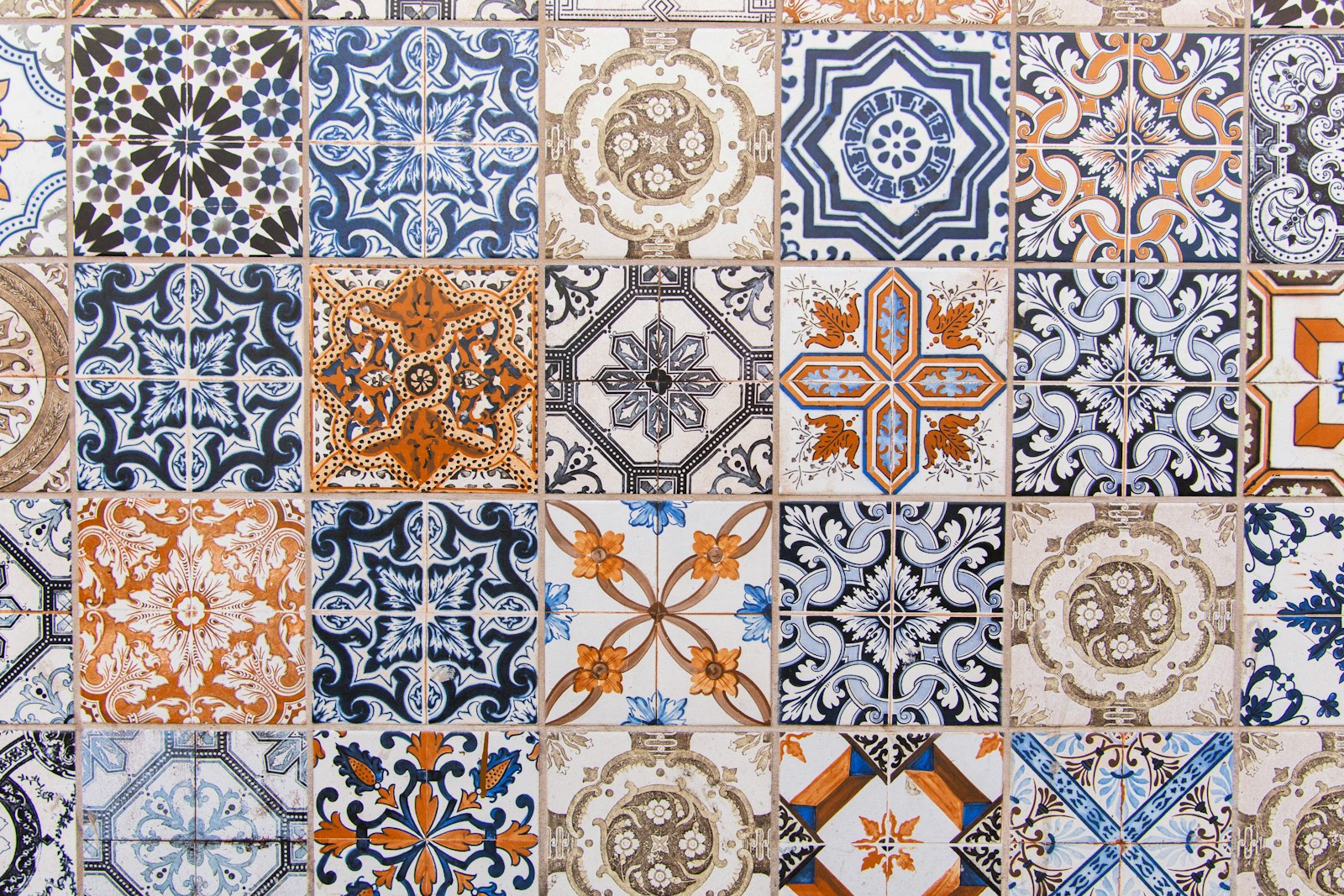 A wall of patterned blue and terracotta tiles