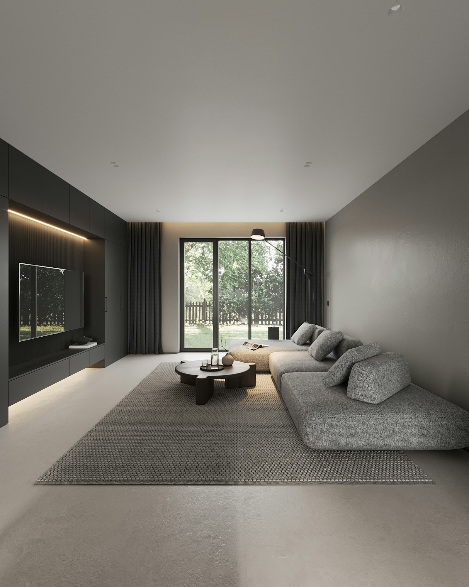 A modern living room with a dark media wall and warm cove lighting