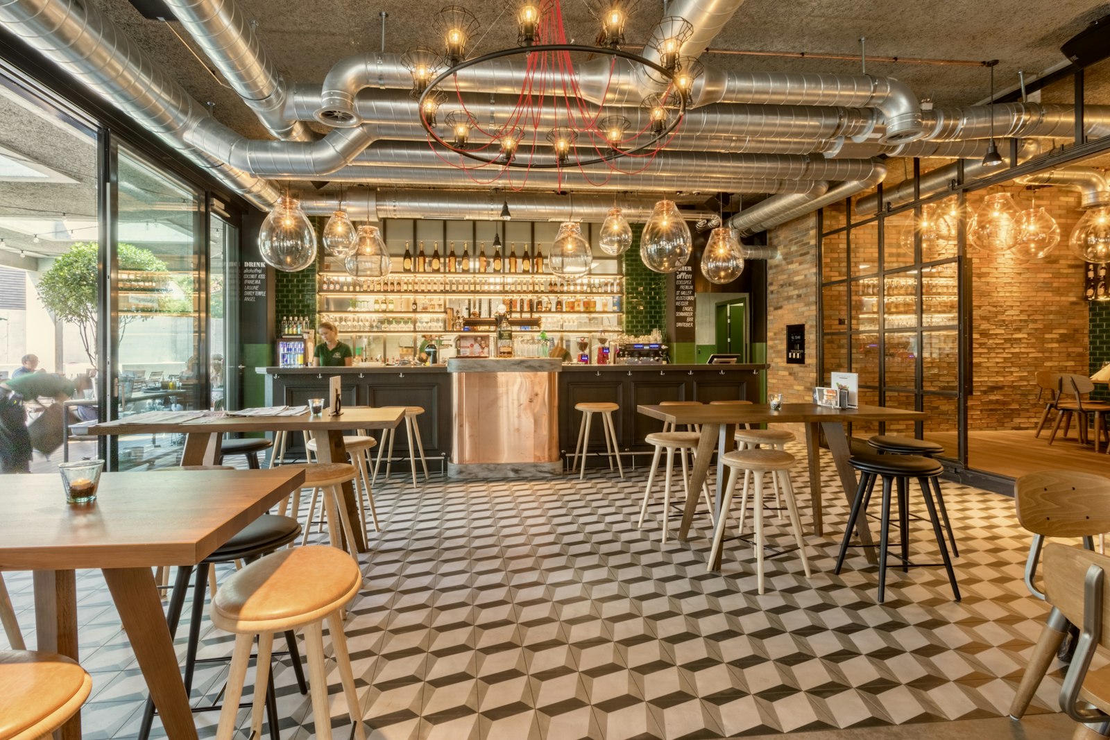 A cafe interior with wooden tables and hanging lights